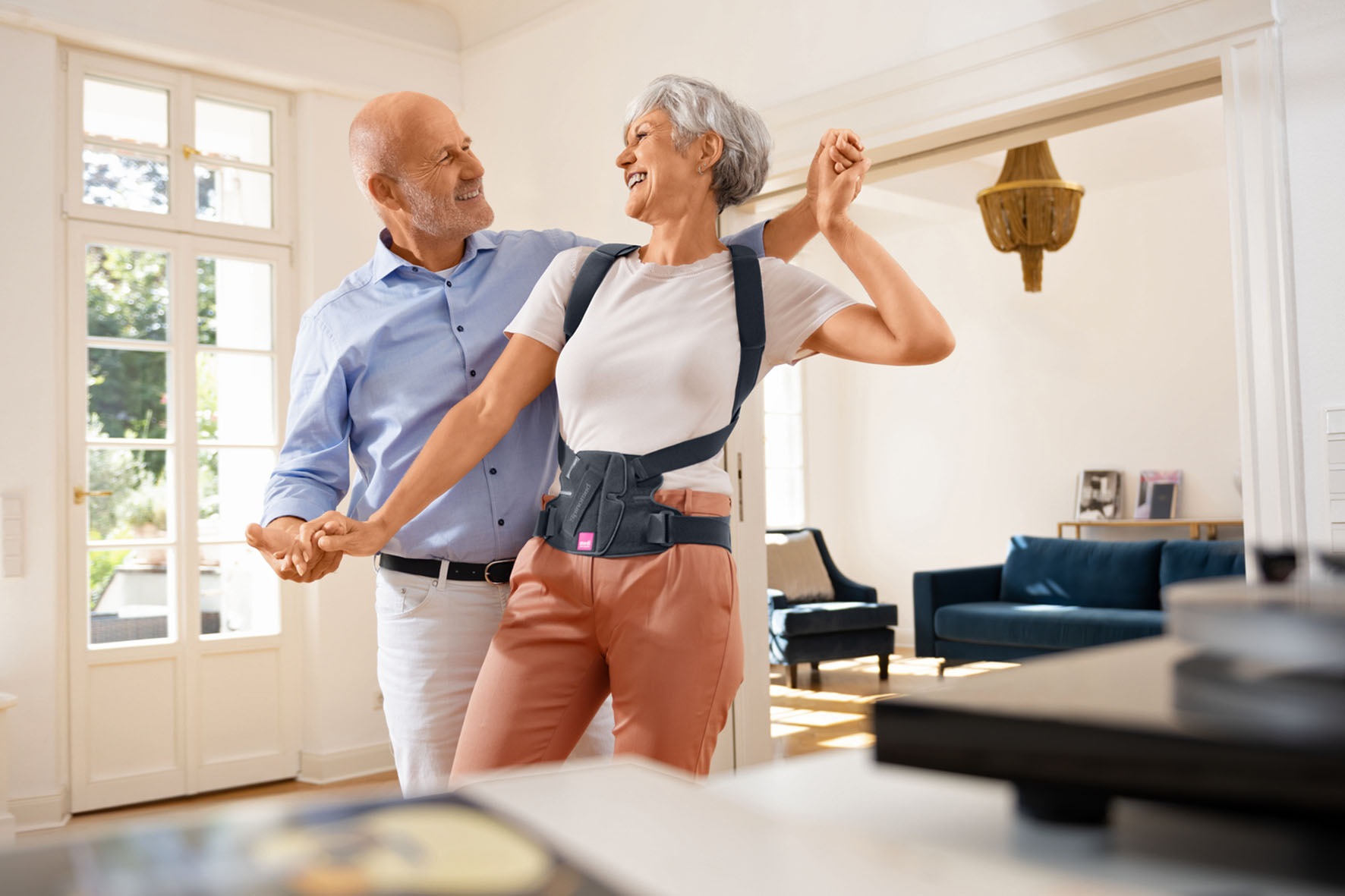 Frau mit Osteoporose tanzt mit ihrem Partner